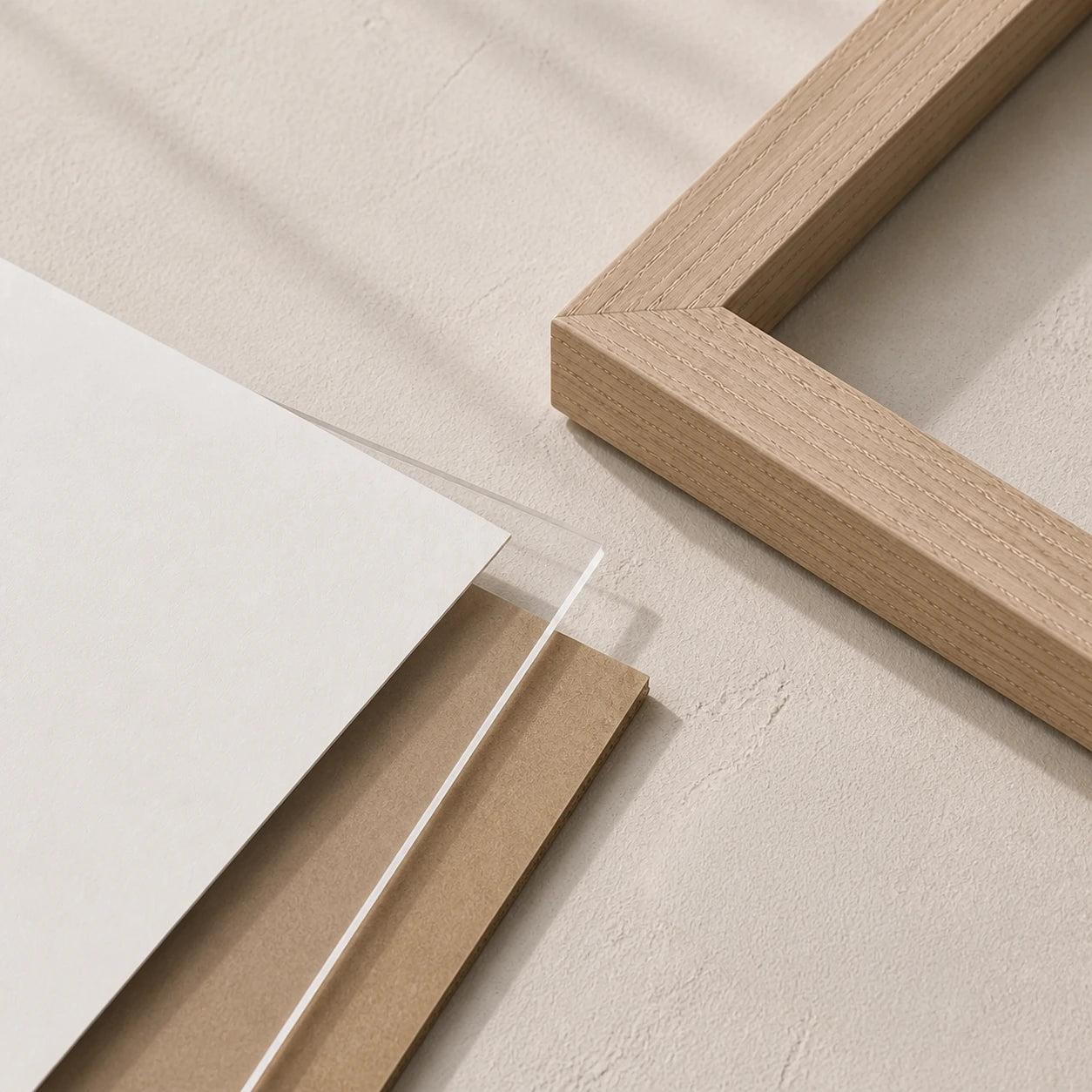 Exploded editorial view of a paper artwork with frame, clear front and backing